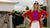 Our model wearing orange cardigan and pink top standing outside